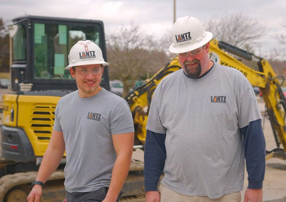 Two Lantz workers walking and smiling together on a site